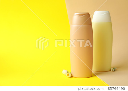 Blank bottles of shampoo on two tone background Blank bottles of shampoo on two tone background 85766490