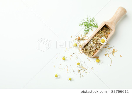 Scoop with dried chamomile on white background Scoop with dried chamomile on white background 85766611