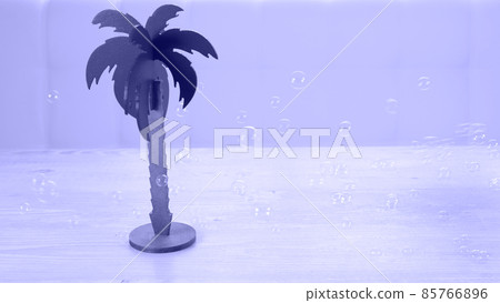 palm tree and rainbow soap bubbles on a white wooden table. Relaxation and imagination concept 85766896