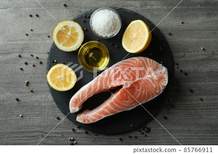 Concept of cooking salmon on gray textured background Concept of cooking salmon on gray textured background 85766911