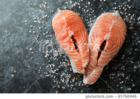 Fresh raw salmon and salt on black smokey background 85766946