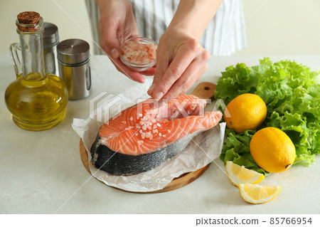 Concept of cooking salmon on white textured background 85766954