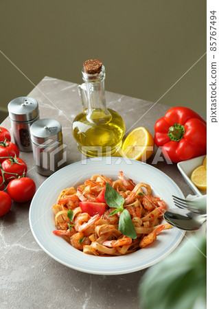 Concept of cooking shrimp pasta on gray textured table Concept of cooking shrimp pasta on gray textured table 85767494