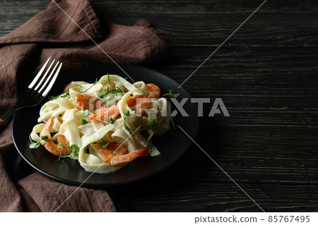 Concept of tasty eating with shrimp pasta on wooden table Concept of tasty eating with shrimp pasta on wooden table 85767495