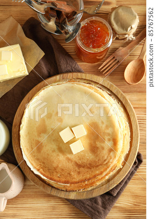 Concept of cooking with crepes on wooden table Concept of cooking with crepes on wooden table 85767562
