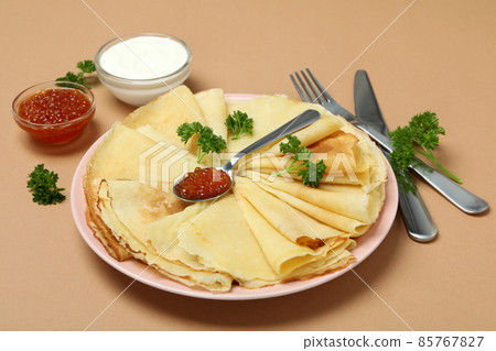Concept of tasty food with crepes on beige background Concept of tasty food with crepes on beige background 85767827