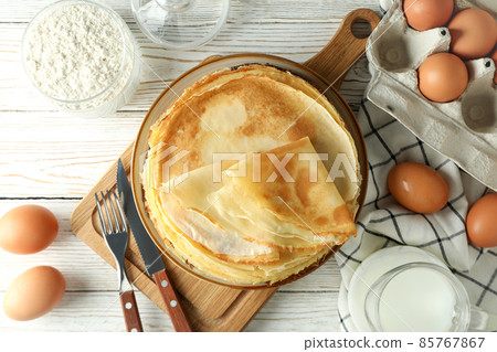 Concept of cooking crepes on white wooden table Concept of cooking crepes on white wooden table 85767867