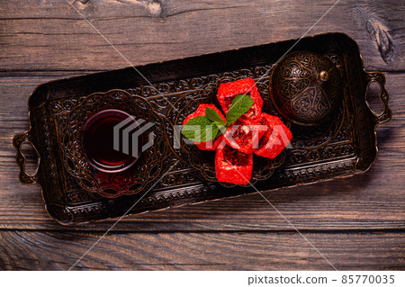 Traditional Turkish Delight with glass of tea Traditional Turkish Delight with glass of tea 85770035