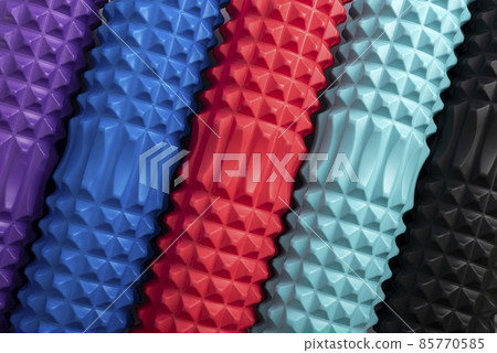 Multicolored foam massage rollers. Close up. Equipment for myofascial release. MFR. Top view Multicolored foam massage rollers. Close up. Equipment for myofascial release. MFR. Top view 85770585