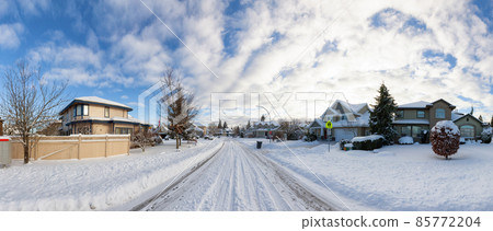Residential Neighborhood in the Suburbs with White Snow covered road Residential Neighborhood in the Suburbs with White Snow covered road 85772204