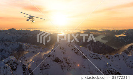 Seaplane Flying over the Rocky Mountain Landscape. Adventure Composite 85772214