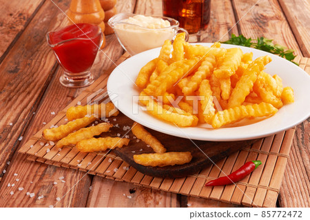 french fries on wooden table 85772472