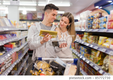 Glad woman and man buying chocolate Glad woman and man buying chocolate 85772730