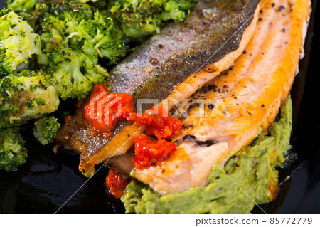 Fried trout with broccoli and sauces 85772779