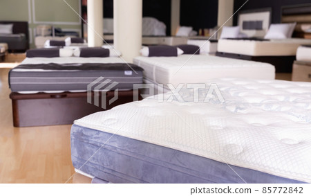 Closeup of new modern orthopaedic mattress on display for sale in large furniture store 85772842