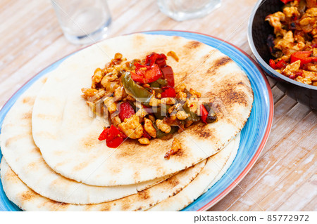 Homemade fajitas with chicken and vegetables served with tortillas Homemade fajitas with chicken and vegetables served with tortillas 85772972