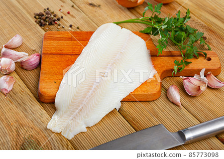 Raw halibut fillet on wooden table Raw halibut fillet on wooden table 85773098