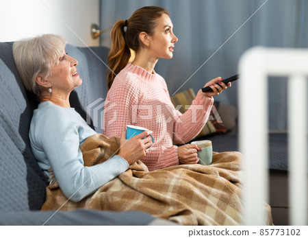 Grandmother and granddaughter watching TV 85773102
