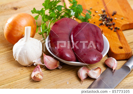 Raw pork kidney with garlic and greens before cooking 85773105