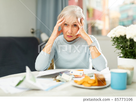 Tired senior woman with financial troubles 85773106