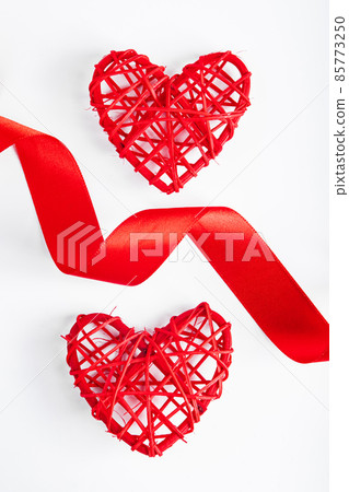 Valentine's day concept. Red silk ribbon and heart on white background. Valentine's day concept. Red silk ribbon and heart on white background. 85773250