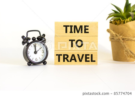 Time to travel symbol. Wooden blocks with concept words 'Time to travel'. Black alarm clock, house plant. Beautiful white background. Business and time to travel concept. Copy space. Time to travel symbol. Wooden blocks with concept words 'Time to travel'. Black alarm clock, house plant. Beautiful white background. Business and time to travel concept. Copy space. 85774704