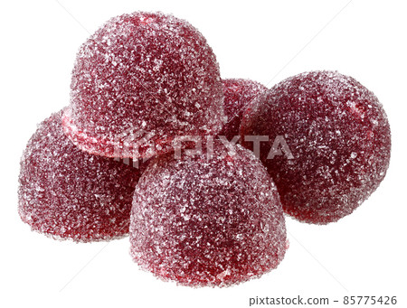 Handful of red and orange candy close up 85775426