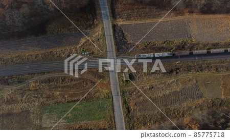 Top View Freight Train Passing Railway Crossing. Aerial Drone View Flight Over 85775718