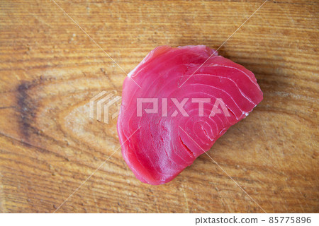 Raw tuna steak on a wooden board, top view. Delicious and healthy food for the body. 85775896