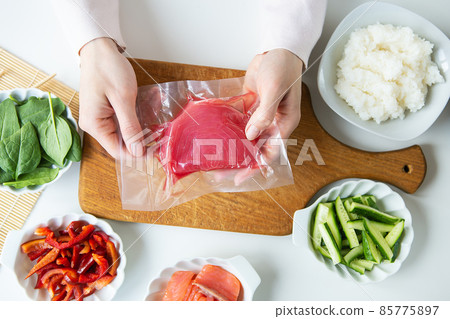 In the process of making sushi, preparing all the ingredients for sushi, tuna in a vacuum. View from above. 85775897