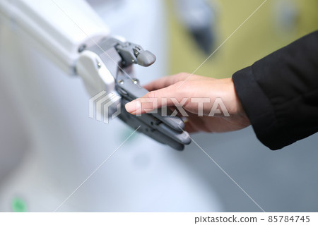 Human and robot handshake, technology of the future 85784745