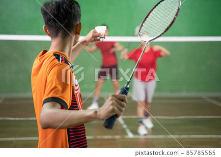 badminton player in orange uniform ready to serve badminton player in orange uniform ready to serve 85785565