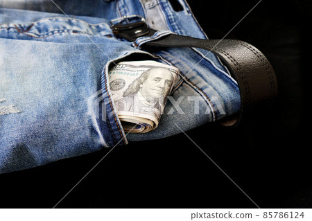 100 usd banknotes visible in the pocket of a jeans lying on the floor, your jeans and 100 usd, 100 usd banknotes visible in the pocket of a jeans lying on the floor, your jeans and 100 usd, 85786124