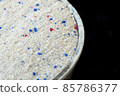a measure of powdered laundry detergent, close-up laundry detergent, 85786377
