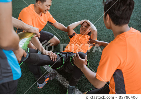 Player sad because of injury during futsal match Player sad because of injury during futsal match 85786406