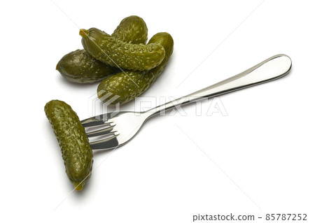 Tasty canned Whole green cornichons isolated on a white background 85787252