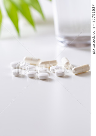 White tablets and capsules on white background White tablets and capsules on white background 85791637