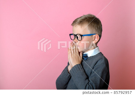 Little kid boy praying, child put hands in asking isolated on pink background. God help me 85792957