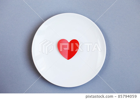 Red Heart on a white plate on grey background 85794059