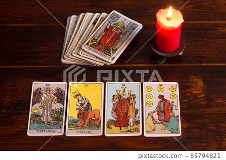 Bangkok,Thailand,March.15.20.On the table are fortune-telling tarot cards and lighted candle.Magic sessions with clairvoyance cards.Reading maps by candlelight 85794821