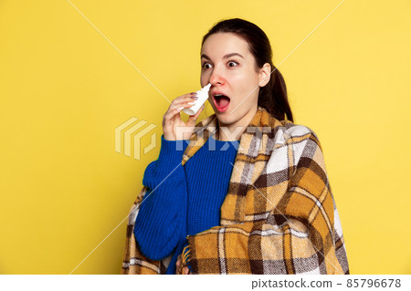 Portrait of Caucasian young woman flu and cold, feeling sick posing isolated on yellow studio background. Portrait of Caucasian young woman flu and cold, feeling sick posing isolated on yellow studio background. 85796678