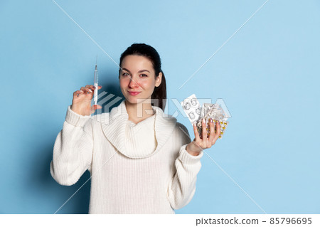 Portrait of young Caucasian girl feeling sick, sneezing isolated over blue background. Flu, cold, allergy 85796695
