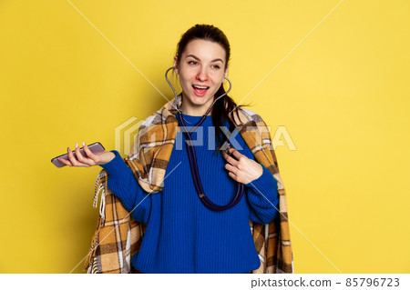 Portrait of Caucasian young woman flu and cold, feeling sick posing isolated on yellow studio background. 85796723