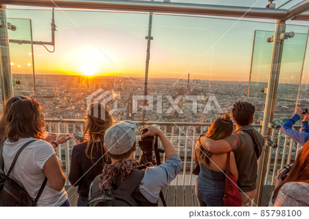 People watching panorama of Paris with Eiffel Tower against colorful sunset in Paris, France People watching panorama of Paris with Eiffel Tower against colorful sunset in Paris, France 85798100
