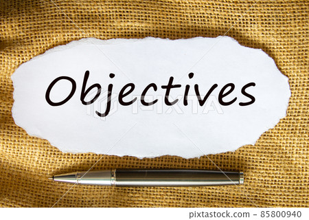 Objectives symbol. The concept word 'Objectives' on white paper. Black metallic pen. Beautiful canvas background. Business and objectives concept. 85800940