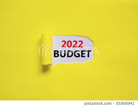 2022 budget new year symbol. Words '2022 budget' appearing behind torn yellow paper. Beautiful yellow background. Business, 2022 budget new year concept, copy space. 85800942