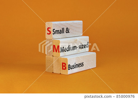 SMB small and medium-sized business symbol. Words SMB small and medium-sized business on blocks on a beautiful orange background. Business and SMB small and medium-sized business concept. Copy space. 85800976