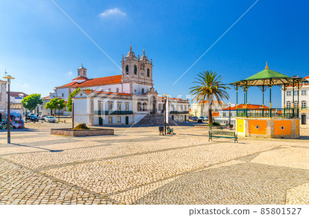 Sanctuary of Our Lady of Nazare catholic church in cobblestone square with palm trees in Sitio hilltop da Nazare town Sanctuary of Our Lady of Nazare catholic church in cobblestone square with palm trees in Sitio hilltop da Nazare town 85801527