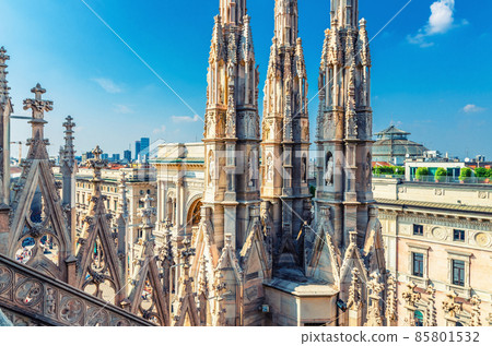 White marble statues on roof of famous Duomo di Milano Cathedral and top aerial view of Milan city centre 85801532