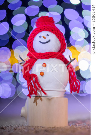 Winter night illuminations and handmade snowman 85802414